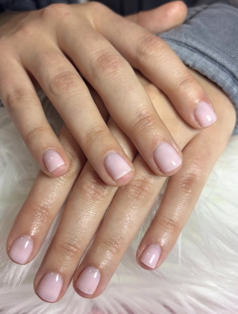 Soft natural-pink short round Russian manicure with a glossy finish